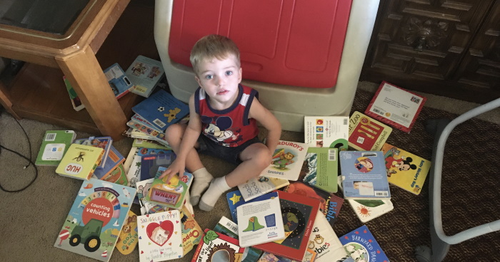 The little guy surrounded by books.